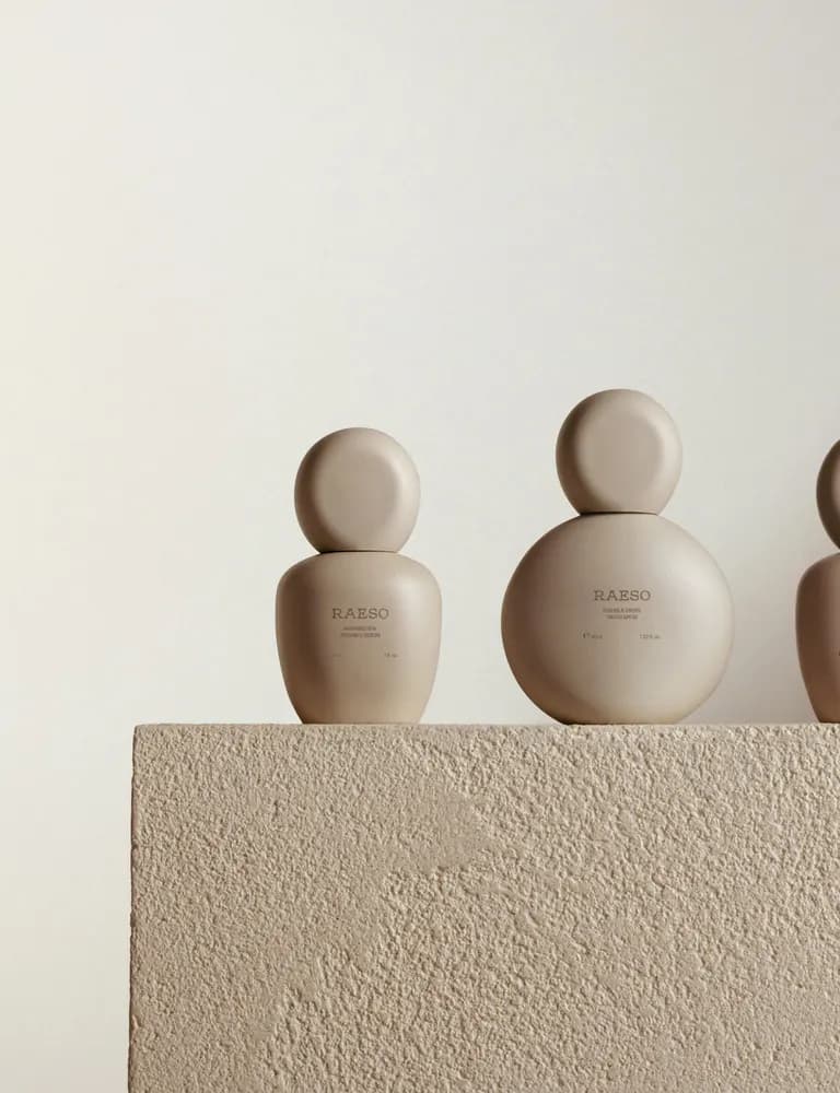 Sculptural skincare vessels on a pedestal