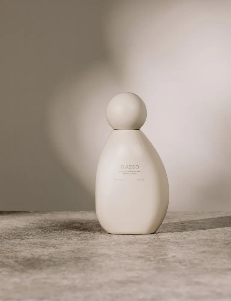 Skincare bottle on a stone surface
