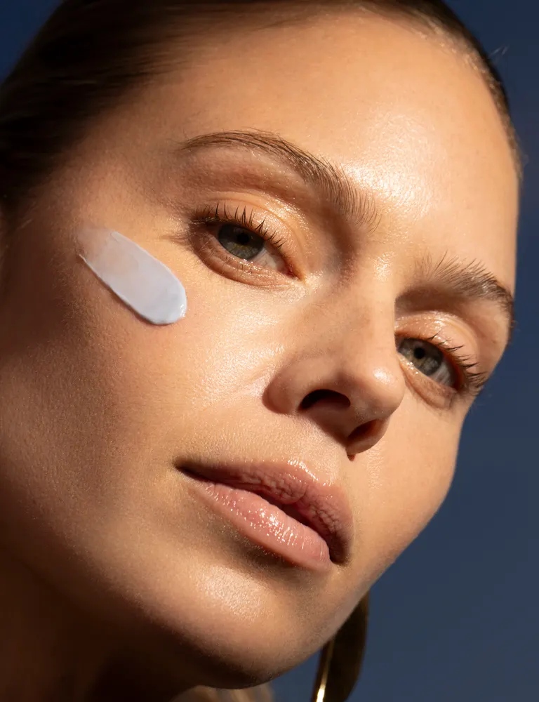 Close-up of a face with cream on cheek