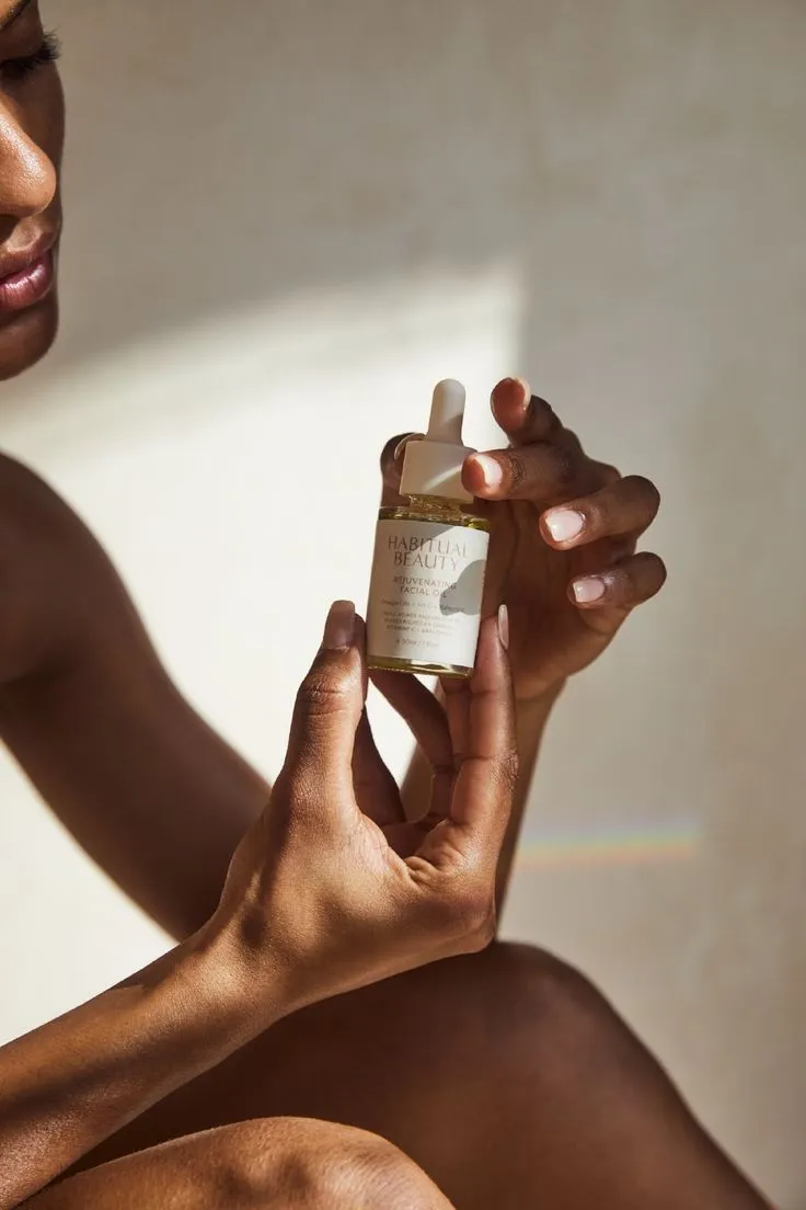 Hands applying skincare product