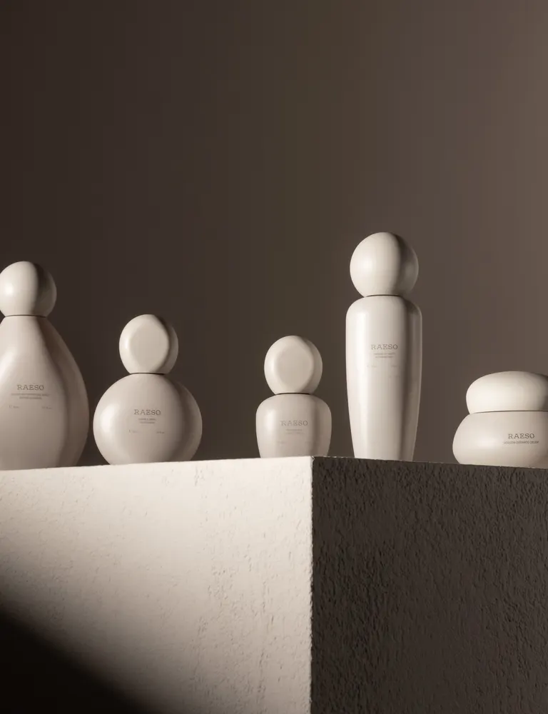 Sculptural skincare vessels in dramatic light
