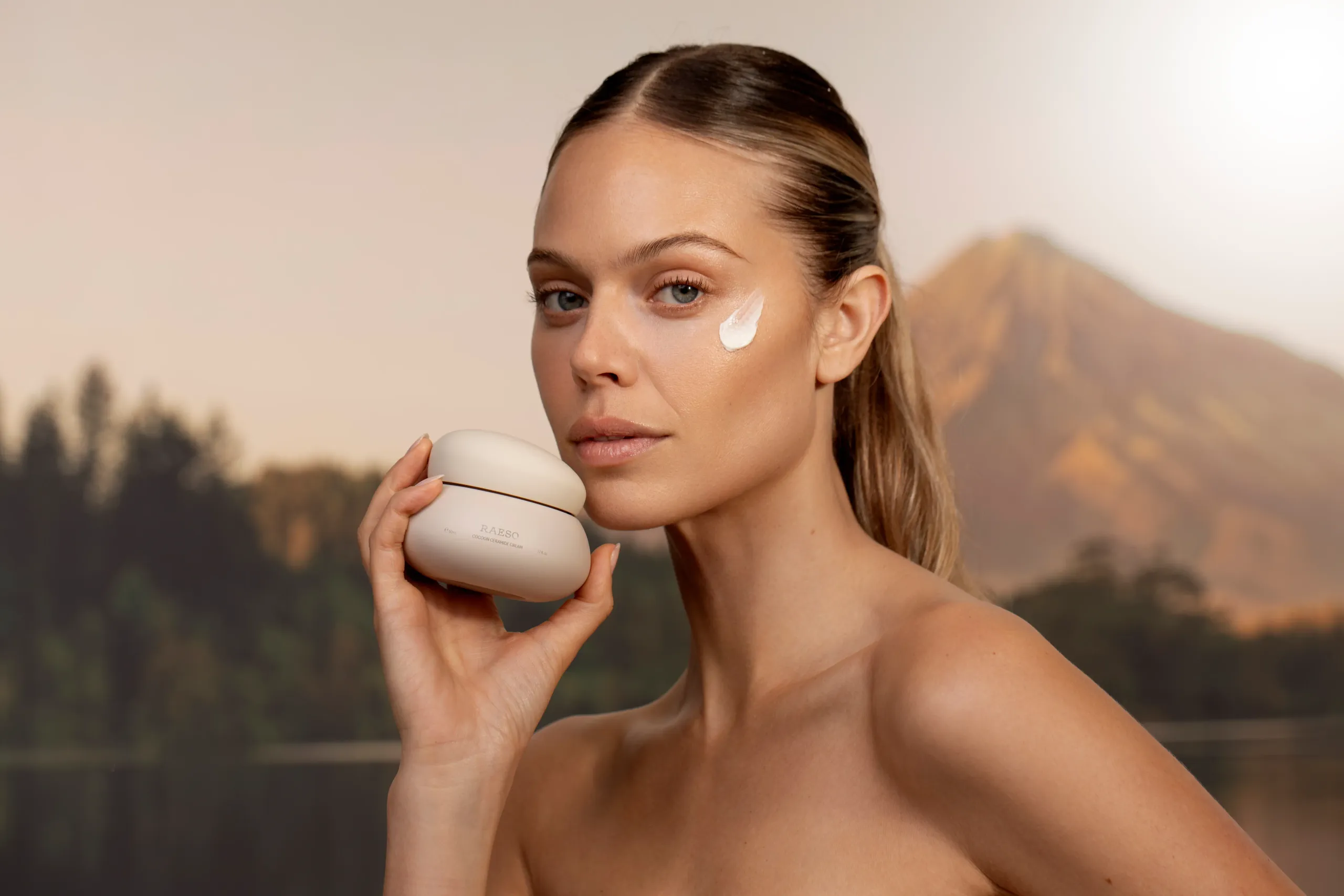 Model applying Raeso Cocoon Ceramide Cream