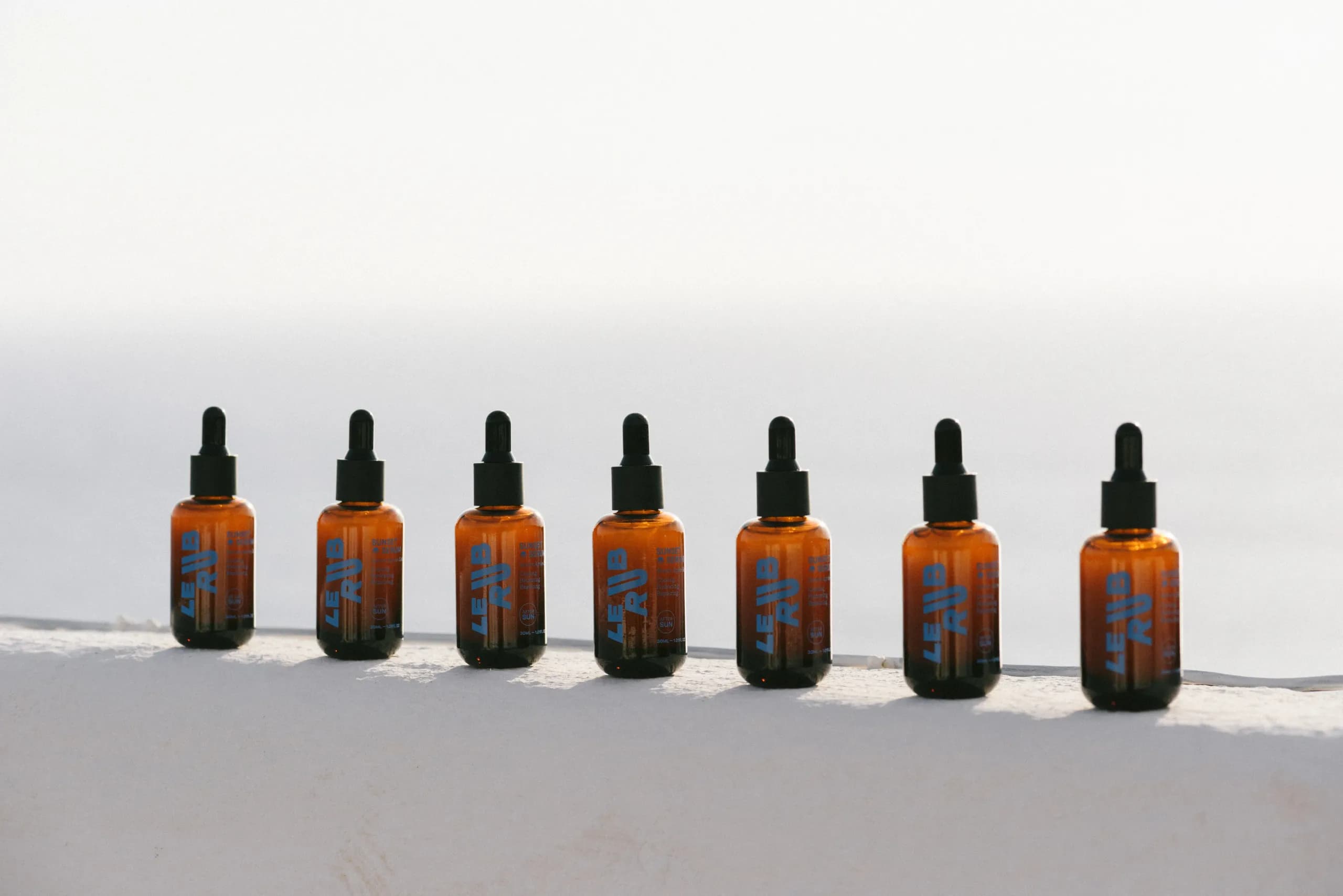 Le Rub Sunset Serum bottles at golden hour